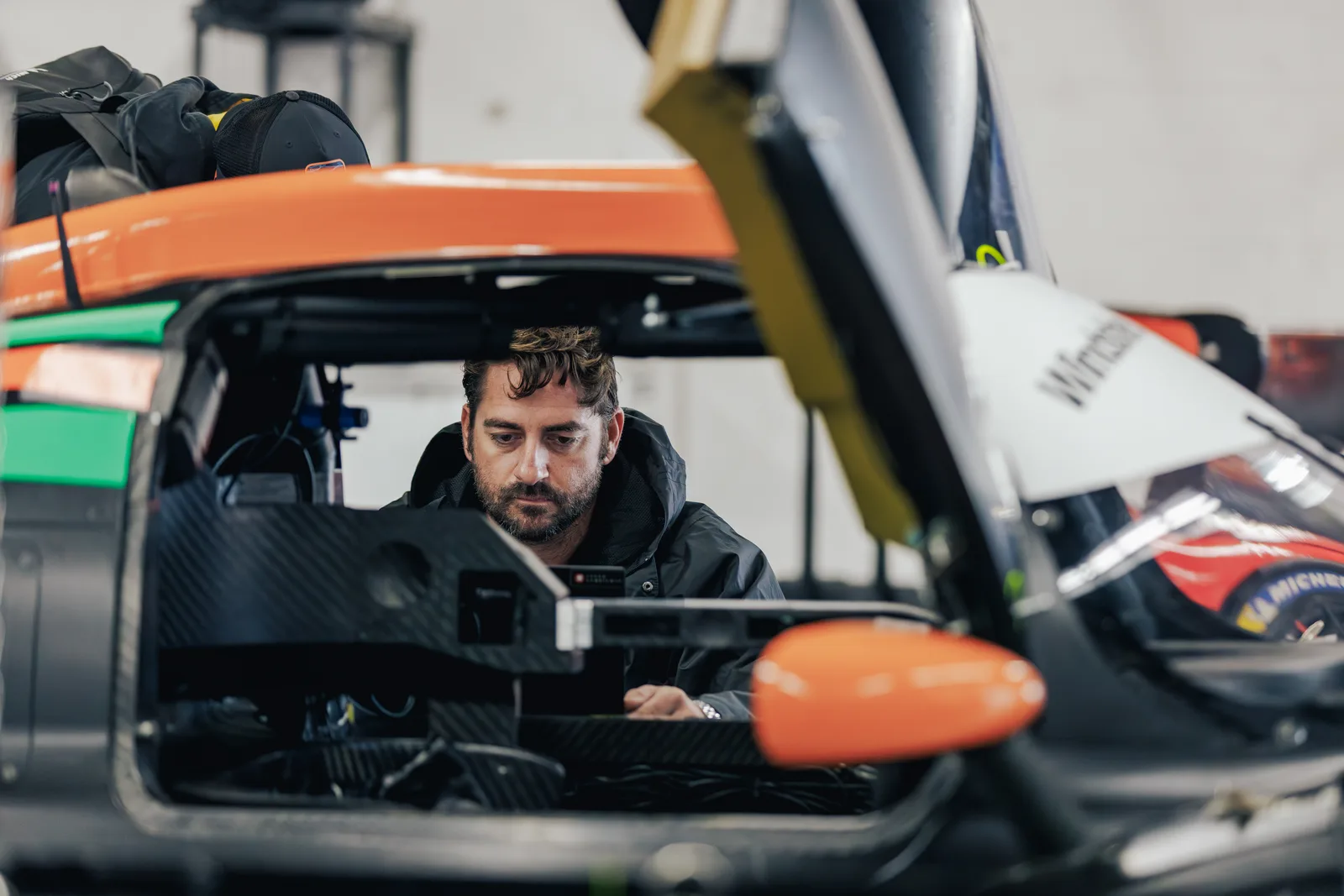 Chris working inside the car’s cockpit at COTA