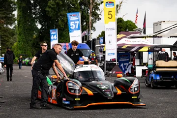 Forbush Performance crew members move the Duqueine through the Road Atlanta paddock.