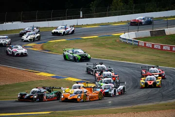 The No. 18 Duqueine leads a long line of race cars through a Road Atlanta corner.