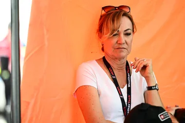 A paddock observer beside the orange team enclosure at Road Atlanta.